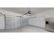 Spacious two-car garage featuring an automatic door opener, a refrigerator and bright interior at 15475 Camp Dubois Cres, Winter Garden, FL 34787