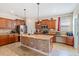 Spacious kitchen features wooden cabinets, a stone island, and stainless steel appliances at 15475 Camp Dubois Cres, Winter Garden, FL 34787