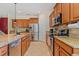 Kitchen features stainless steel appliances, granite countertops, wooden cabinets at 15475 Camp Dubois Cres, Winter Garden, FL 34787