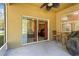 View of the covered lanai and backyard with sliding door and patio furniture at 15475 Camp Dubois Cres, Winter Garden, FL 34787