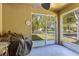 Covered lanai with grill, ceiling fan, and view to the front yard at 15475 Camp Dubois Cres, Winter Garden, FL 34787