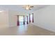 Open-concept living room with tile flooring, ceiling fan and sliding door access to the porch at 15475 Camp Dubois Cres, Winter Garden, FL 34787