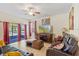 Comfortable living room with leather sofas, tile flooring, ceiling fan and sliding door access to the porch at 15475 Camp Dubois Cres, Winter Garden, FL 34787