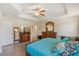Bright main bedroom features wood floors, a tray ceiling, and a large bed with decor pillows at 15475 Camp Dubois Cres, Winter Garden, FL 34787