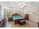 Large main bedroom features wood floors, a tray ceiling, and matching decor at 15475 Camp Dubois Cres, Winter Garden, FL 34787