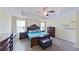 The main bedroom features a tray ceiling, wood floors, and matching furniture at 15475 Camp Dubois Cres, Winter Garden, FL 34787