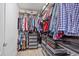 Organized walk-in closet featuring shelving, hanging rods, and storage drawers at 15475 Camp Dubois Cres, Winter Garden, FL 34787