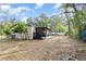 Backyard featuring screen porch and a view of the back of the home and side yard at 1638 Leesburg Blvd, Fruitland Park, FL 34731