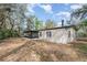 Backyard view of a home with light siding, black shutters, and screened porch at 1638 Leesburg Blvd, Fruitland Park, FL 34731