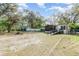 A shot of the backyard highlighting a ramp to the screen porch and a white fence at 1638 Leesburg Blvd, Fruitland Park, FL 34731
