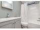 Bathroom features a shower/tub combination, gray vanity and grey paint throughout at 1638 Leesburg Blvd, Fruitland Park, FL 34731