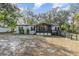 Charming home with light siding, black shutters, wheelchair ramp and a screened in porch at 1638 Leesburg Blvd, Fruitland Park, FL 34731