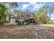 Quaint home featuring light siding, black shutters, screened porch and wheelchair ramp at 1638 Leesburg Blvd, Fruitland Park, FL 34731