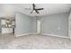 Living room with neutral paint, a ceiling fan and adjacent kitchen at 1638 Leesburg Blvd, Fruitland Park, FL 34731