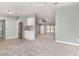 Open living space with a refrigerator, modern lighting and gray walls at 1638 Leesburg Blvd, Fruitland Park, FL 34731