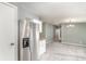Open space with a stainless steel refrigerator and view to a carpeted room at 1638 Leesburg Blvd, Fruitland Park, FL 34731