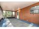 Enclosed back porch area featuring wood paneling, a door to the backyard, and a window at 1638 Leesburg Blvd, Fruitland Park, FL 34731