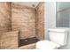 Updated shower featuring modern wood tile, black hexagon tile and a built in shower bench at 1638 Leesburg Blvd, Fruitland Park, FL 34731