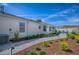 A backyard features an air conditioner, lush landscaping, a patio, and walkway at 17714 Se 84Th Sheldon Ter, The Villages, FL 32162