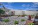 A rock garden is surrounded by landscaping and a privacy wall at 17714 Se 84Th Sheldon Ter, The Villages, FL 32162