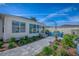 A backyard features a patio with Adirondack chairs, a fire pit, landscaping, and archway at 17714 Se 84Th Sheldon Ter, The Villages, FL 32162