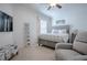 Serene bedroom with soft gray tones, decorative accents, and a comfortable upholstered armchair at 17714 Se 84Th Sheldon Ter, The Villages, FL 32162