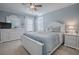 Inviting bedroom featuring a white wooden bed frame, light blue walls, and coordinating dresser and nightstand at 17714 Se 84Th Sheldon Ter, The Villages, FL 32162