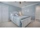 Cozy bedroom with blue walls, crown molding, and a comfortable bed with blue and white patterned bedding at 17714 Se 84Th Sheldon Ter, The Villages, FL 32162