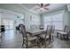 Open dining area adjacent to the living area, with a modern table set and a ceiling fan at 17714 Se 84Th Sheldon Ter, The Villages, FL 32162