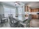 Bright dining area with a ceiling fan and large windows, adjacent to the kitchen at 17714 Se 84Th Sheldon Ter, The Villages, FL 32162