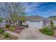Charming home with a well-maintained lawn, driveway, and an attached two-car garage at 17714 Se 84Th Sheldon Ter, The Villages, FL 32162