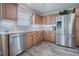 Modern kitchen with stainless steel appliances, light countertops, and ample wood cabinetry at 17714 Se 84Th Sheldon Ter, The Villages, FL 32162