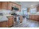 This kitchen features stainless steel appliances, ample counter space and light wood cabinets at 17714 Se 84Th Sheldon Ter, The Villages, FL 32162