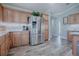 Well-lit kitchen featuring a stainless steel refrigerator, and ample cabinet space at 17714 Se 84Th Sheldon Ter, The Villages, FL 32162