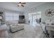 Bright living room featuring a ceiling fan, comfortable seating, and view into the adjacent office at 17714 Se 84Th Sheldon Ter, The Villages, FL 32162