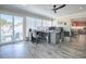 Bright home office featuring a large desk, modern ceiling fan, and patio access at 17714 Se 84Th Sheldon Ter, The Villages, FL 32162