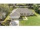 A single story home features mature trees, well-manicured lawn and a two-car garage at 1792 Presidio Dr, Clermont, FL 34711
