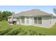 Lush backyard with a patio set and grill perfect for outdoor dining and entertaining at 1792 Presidio Dr, Clermont, FL 34711