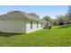 Back exterior view of a home with a green lawn and patio area at 1792 Presidio Dr, Clermont, FL 34711