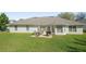 A lovely backyard with green grass, patio table and chairs perfect for outdoor entertaining at 1792 Presidio Dr, Clermont, FL 34711