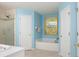 Bathroom features a garden tub, walk-in shower, and blue painted walls at 1792 Presidio Dr, Clermont, FL 34711