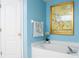 Bright bathroom features a soaking tub and a decorative floral art piece at 1792 Presidio Dr, Clermont, FL 34711