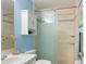 Bathroom with a glass shower, vanity with storage, and coastal-inspired decor at 1792 Presidio Dr, Clermont, FL 34711