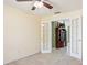 This bedroom shows open doors, carpeted floors, and a view into the next room at 1792 Presidio Dr, Clermont, FL 34711