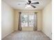 A modest bedroom with a ceiling fan and a window with curtain accents at 1792 Presidio Dr, Clermont, FL 34711