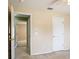 A bedroom view includes 2 entry doors, neutral colors and carpeted floors at 1792 Presidio Dr, Clermont, FL 34711