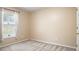 Neutral bedroom featuring a window with blinds, carpeted floors, and a door at 1792 Presidio Dr, Clermont, FL 34711