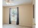 A standard bedroom featuring a window with curtains and neutral colors throughout at 1792 Presidio Dr, Clermont, FL 34711