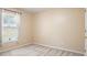 Bedroom featuring a window with blinds, carpeted floors, and a door at 1792 Presidio Dr, Clermont, FL 34711