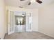 An airy bedroom with open doors and a window to allow for natural light and air flow at 1792 Presidio Dr, Clermont, FL 34711